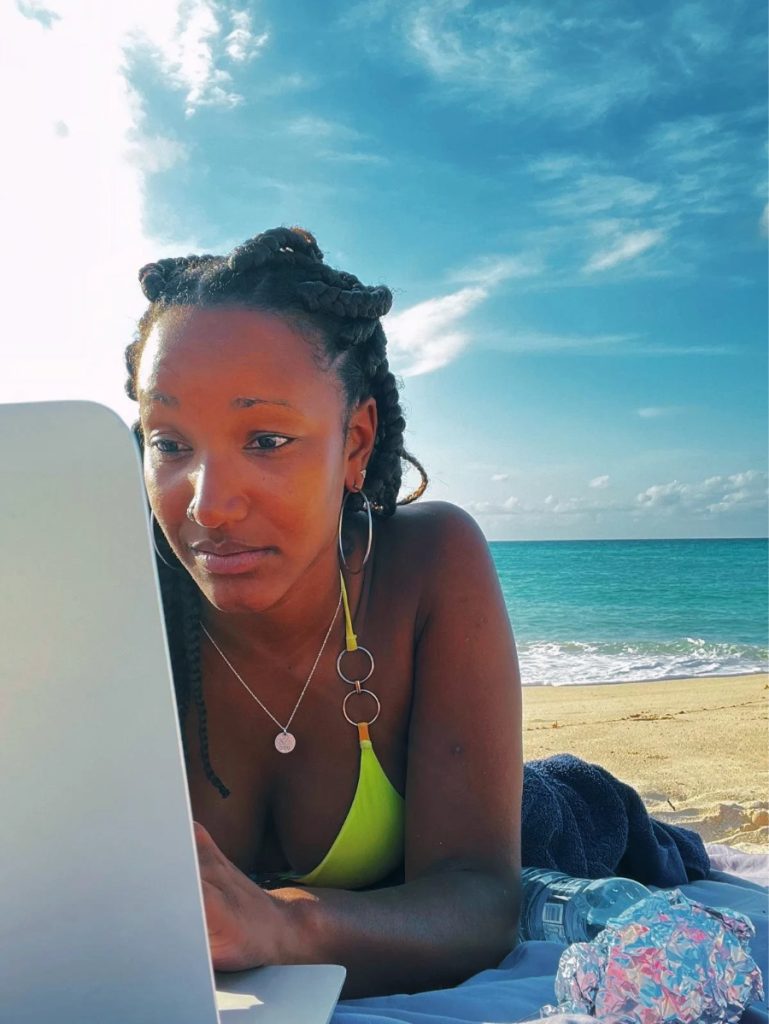 A woman at a seaside café looks up a business on her phone